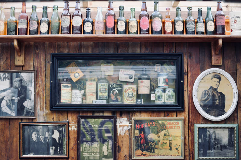 pub wall with framed images bottles
