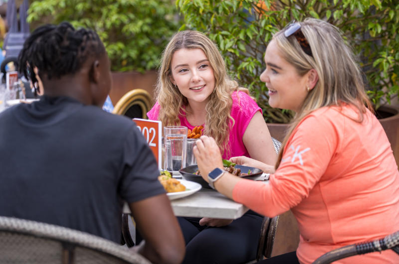 teenagers having meal at outdoor cafe