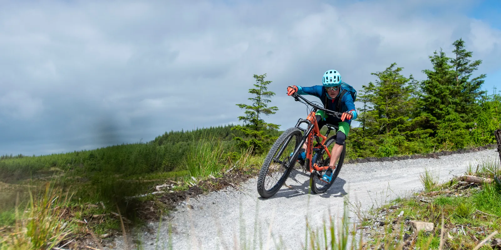 header outdoor adventures man on mountain bike turning corner
