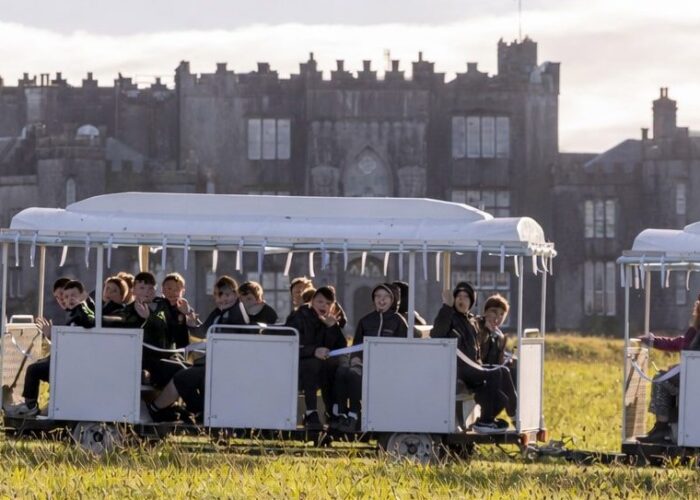 White tourist train by the castle e1770224723379